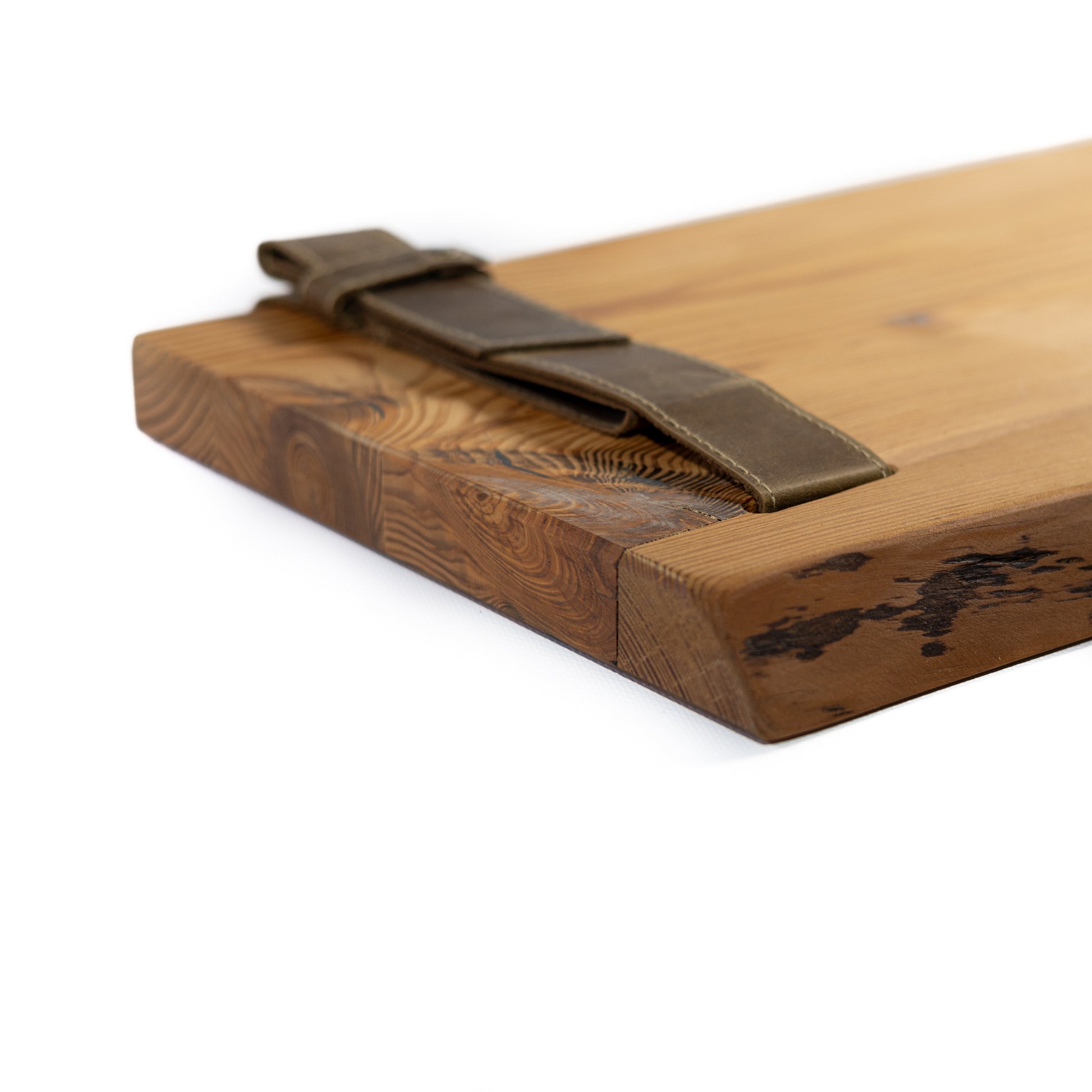 Close-up of amber pine wood grain and genuine leather straps
